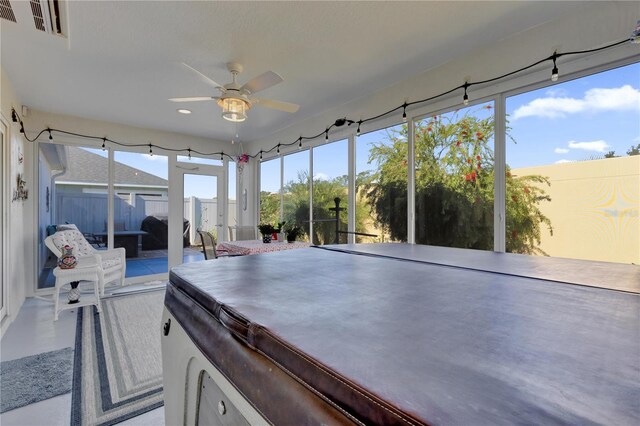 sunroom / solarium featuring ceiling fan