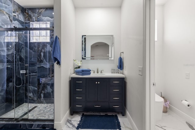 bathroom featuring vanity, toilet, and a shower with shower door