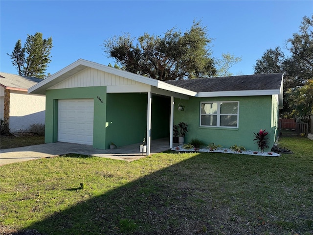 single story home featuring a front lawn and a garage