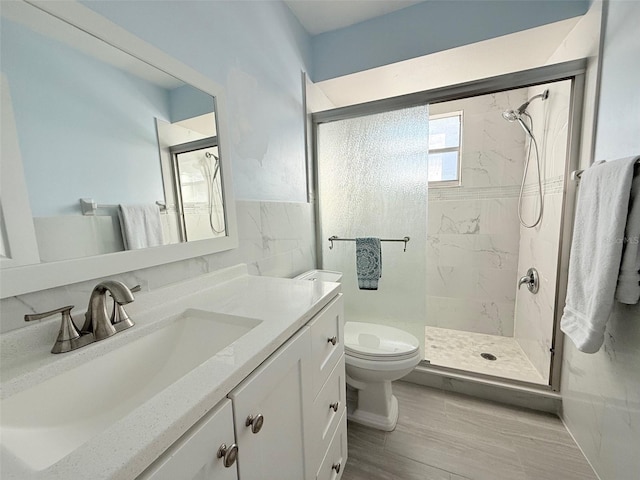 bathroom with vanity, toilet, and a shower with shower door