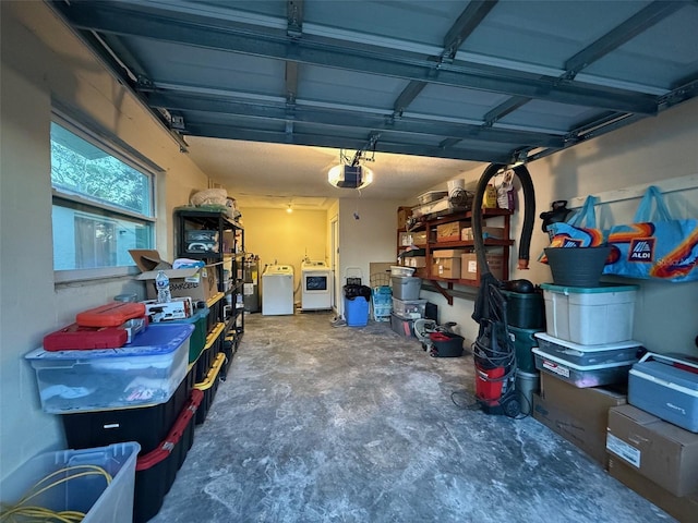 garage featuring washing machine and dryer and a garage door opener