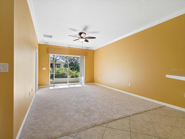 empty room featuring crown molding, light tile patterned floors, and ceiling fan