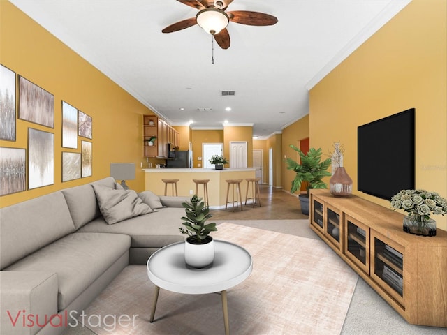 living room featuring ceiling fan and ornamental molding