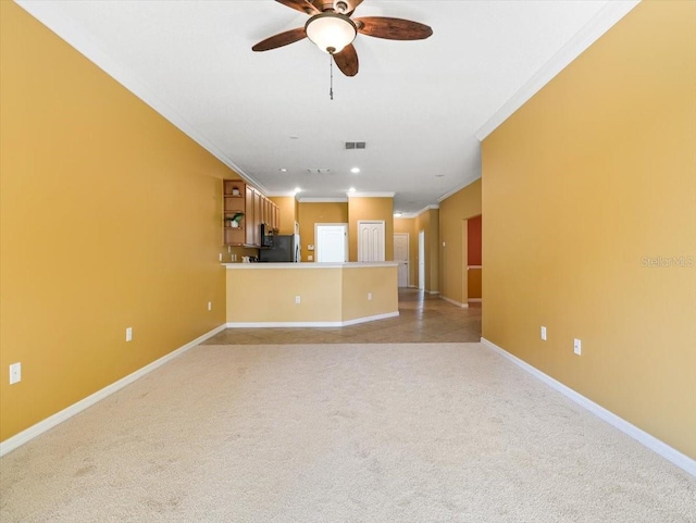 unfurnished living room with light carpet, crown molding, and ceiling fan