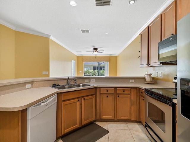 kitchen featuring sink, ceiling fan, light tile patterned floors, appliances with stainless steel finishes, and kitchen peninsula