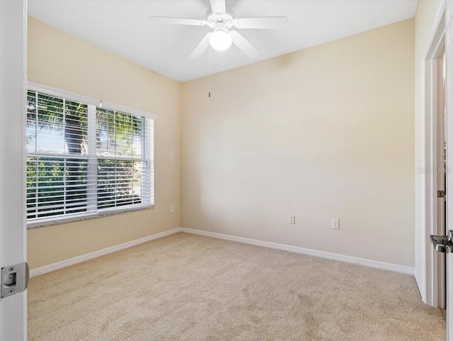 carpeted empty room featuring ceiling fan