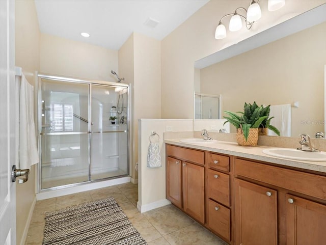 bathroom featuring tile patterned flooring, vanity, and a shower with door