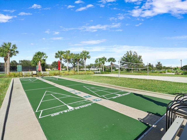 view of property's community with a yard and volleyball court