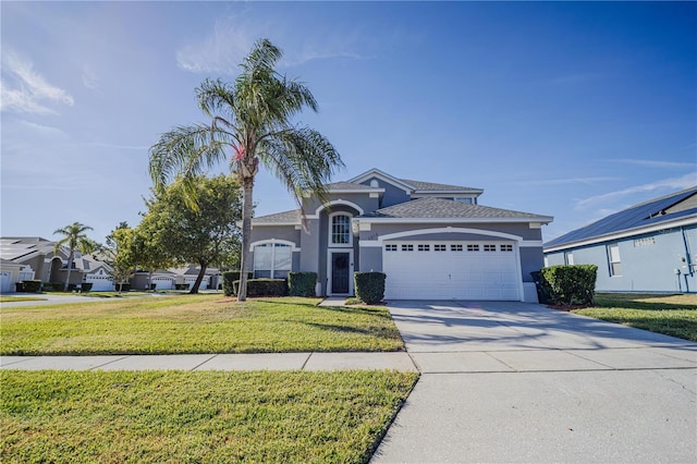 view of front of property with a front yard and a garage