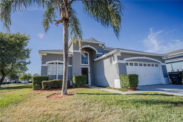 view of front of home with a front lawn and a garage