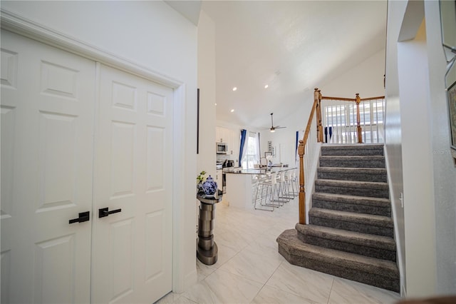 interior space featuring ceiling fan and vaulted ceiling