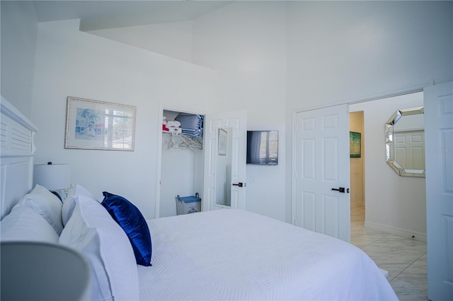 bedroom with high vaulted ceiling