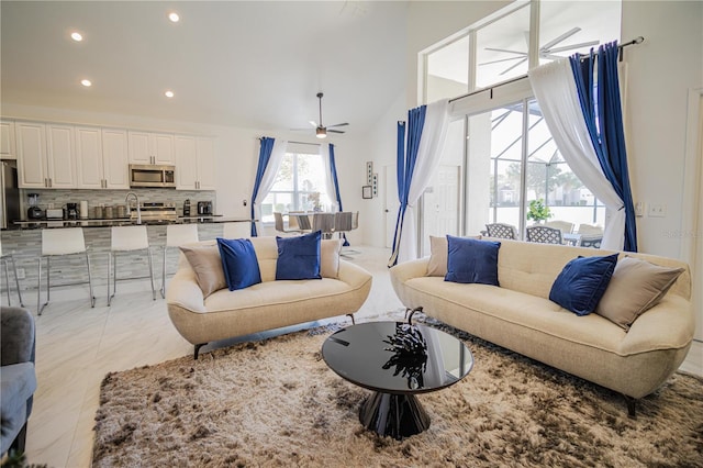 tiled living room featuring ceiling fan