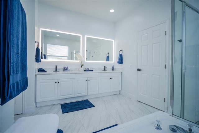 bathroom with vanity and a shower with door