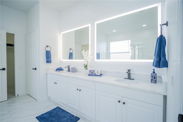 bathroom with vanity and a shower with shower door