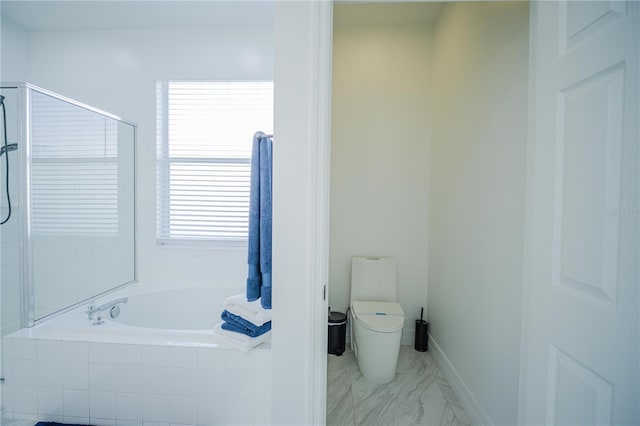 bathroom featuring toilet and independent shower and bath