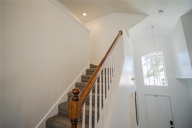 stairs featuring a high ceiling