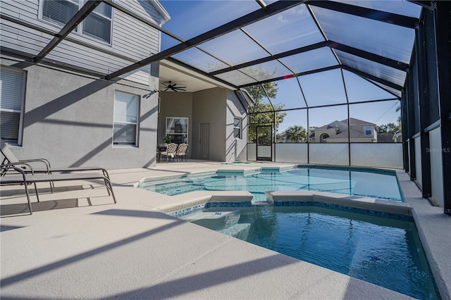 view of swimming pool featuring a lanai, a patio area, and an in ground hot tub