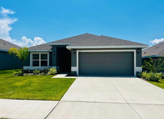 single story home with a garage and a front lawn