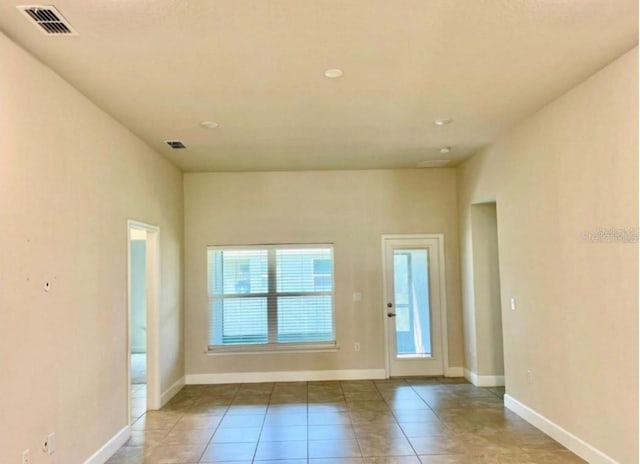 doorway to outside featuring light tile patterned flooring