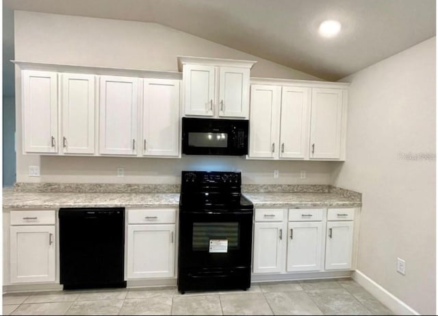 kitchen featuring white cabinets, black appliances, and lofted ceiling