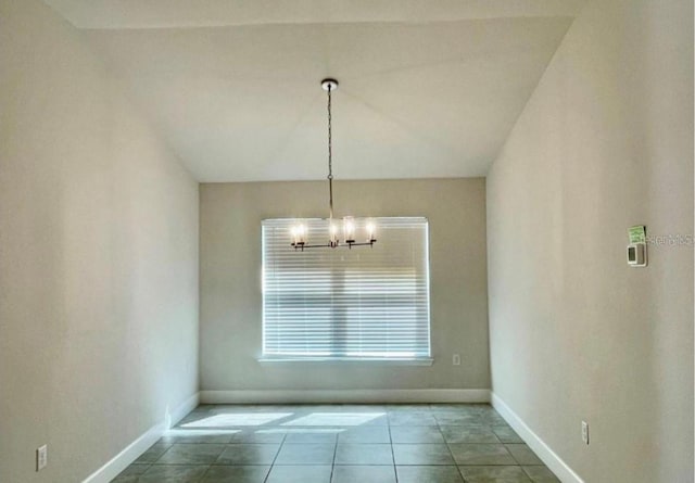 unfurnished dining area featuring a chandelier and tile patterned floors