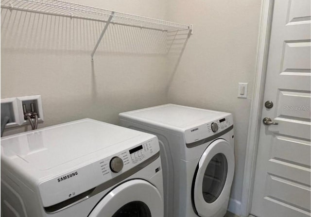 clothes washing area with separate washer and dryer