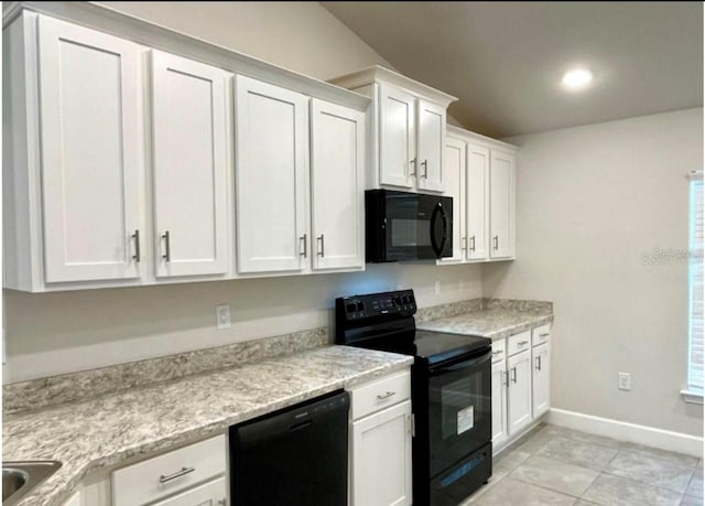 kitchen featuring light stone counters, white cabinets, black appliances, and light tile patterned floors