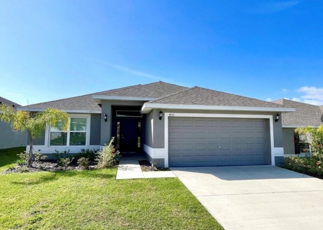 view of front facade featuring a front yard and a garage