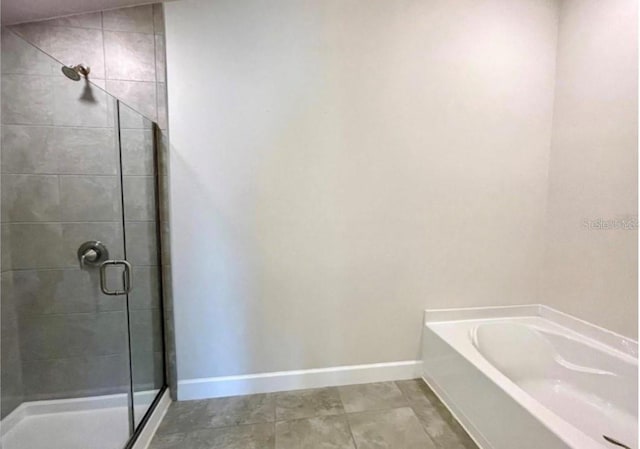 bathroom with tile patterned flooring and independent shower and bath