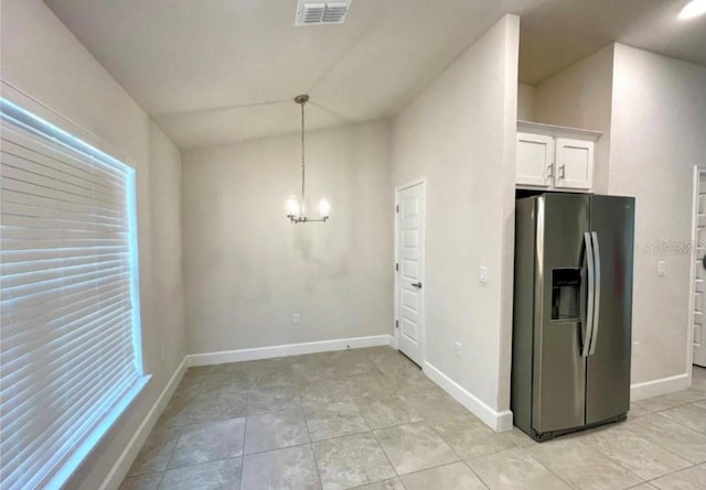 kitchen featuring stainless steel fridge with ice dispenser, white cabinets, pendant lighting, and a notable chandelier