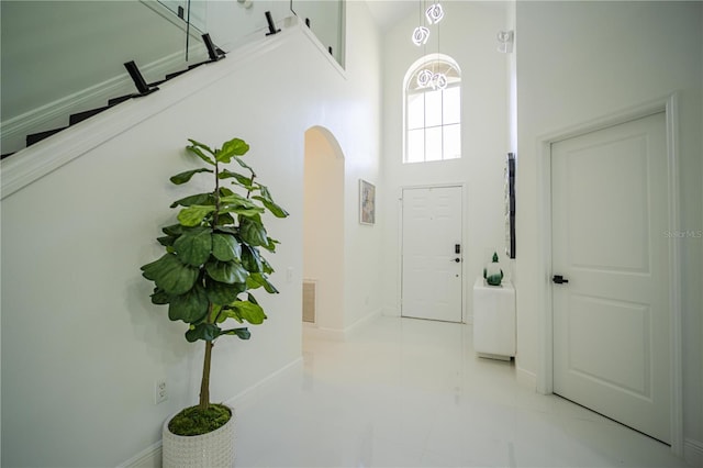 entrance foyer featuring light tile patterned floors and a high ceiling