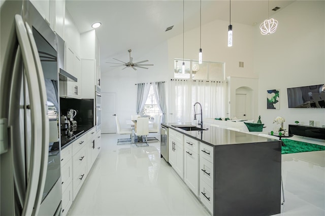 kitchen featuring hanging light fixtures, sink, white cabinets, and stainless steel appliances