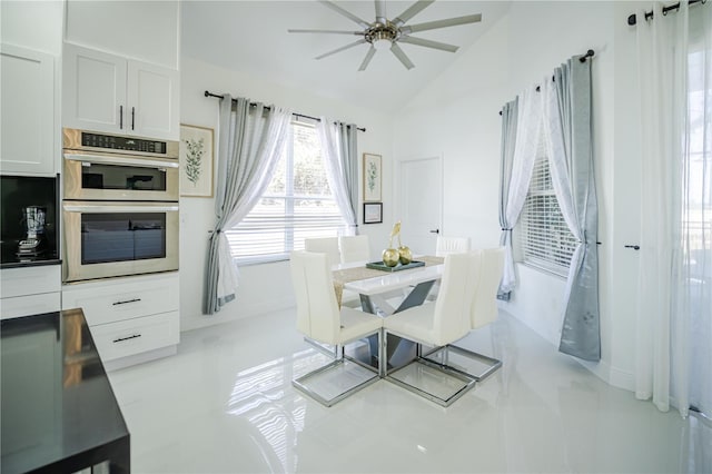 dining area with ceiling fan and lofted ceiling