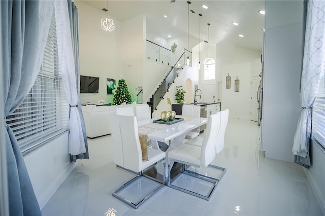 dining room with light tile patterned flooring, sink, and an inviting chandelier