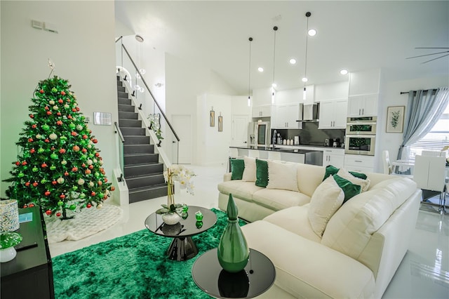 living room with vaulted ceiling, ceiling fan, and sink