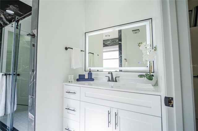 bathroom featuring vanity and an enclosed shower