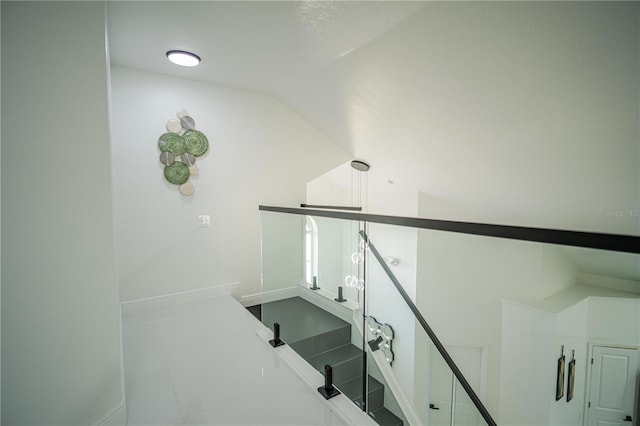 staircase featuring vaulted ceiling