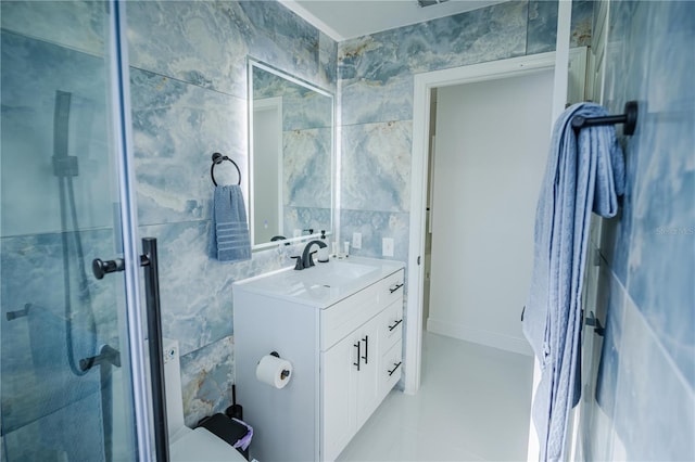 bathroom with vanity, toilet, tile walls, and walk in shower