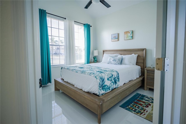 bedroom featuring tile patterned floors, multiple windows, and ceiling fan