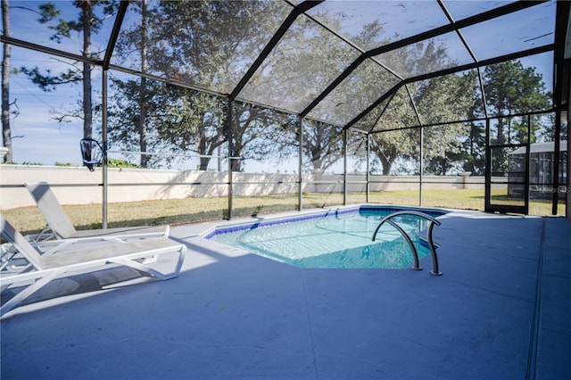 view of swimming pool featuring a lanai and a patio