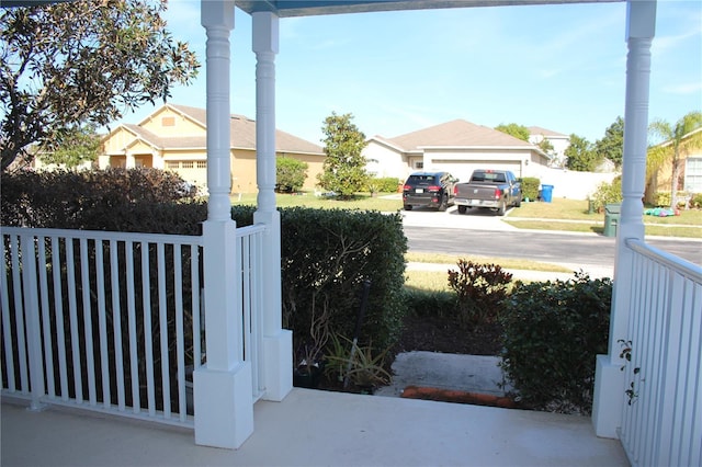 view of yard with a garage and covered porch