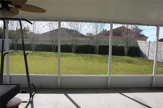 unfurnished sunroom with ceiling fan