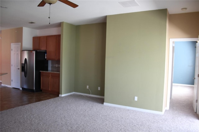 kitchen with stainless steel fridge, ceiling fan, and dark colored carpet