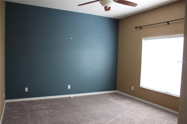 spare room with light carpet and ceiling fan