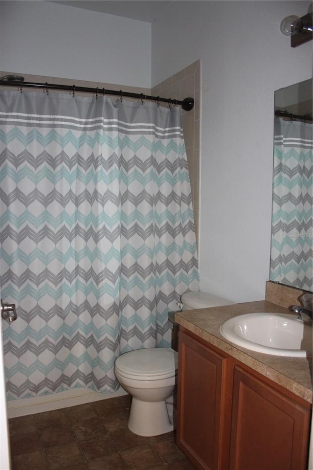 bathroom with vanity, tile patterned flooring, and toilet