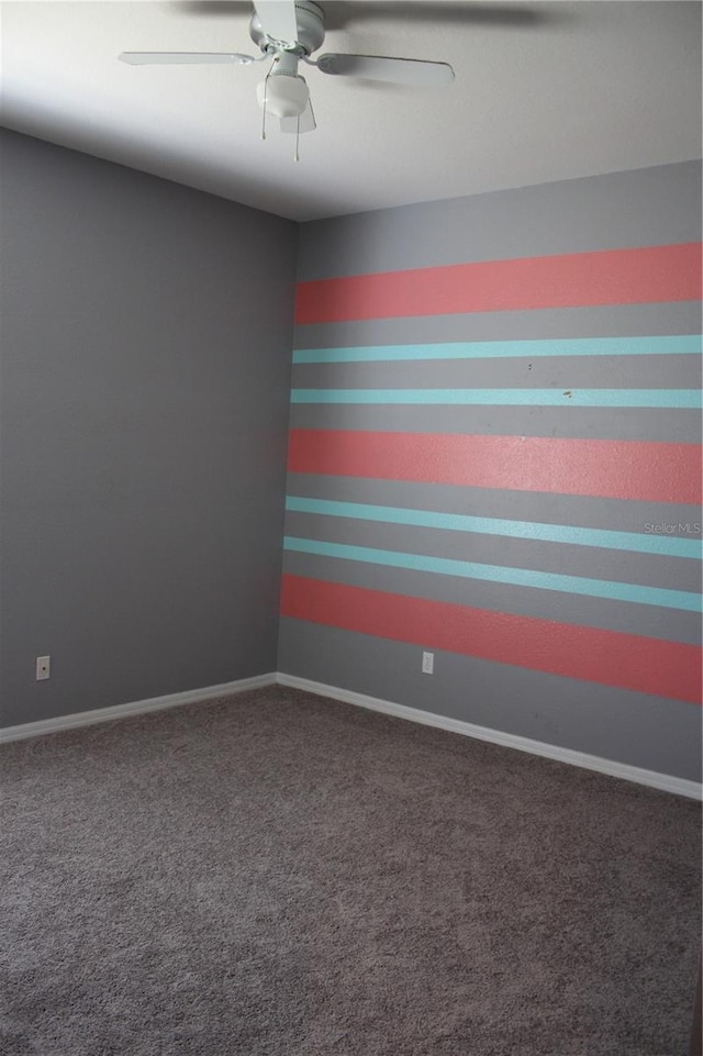 carpeted empty room featuring ceiling fan