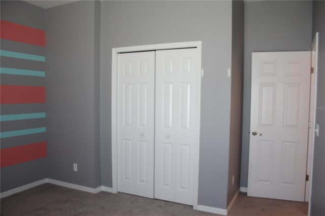 unfurnished bedroom with a closet and carpet