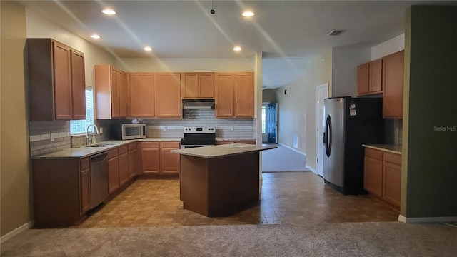 kitchen featuring a kitchen island, appliances with stainless steel finishes, tasteful backsplash, sink, and light colored carpet