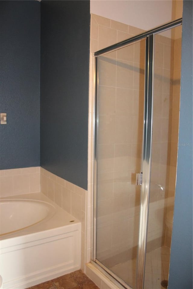 bathroom featuring shower with separate bathtub and tile patterned floors